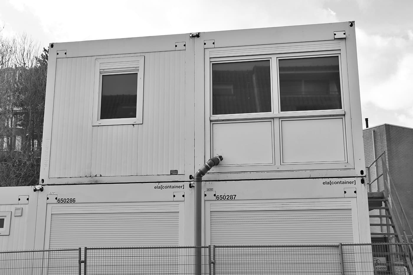Stacked modular cabin units forming a two-storey site accommodation block